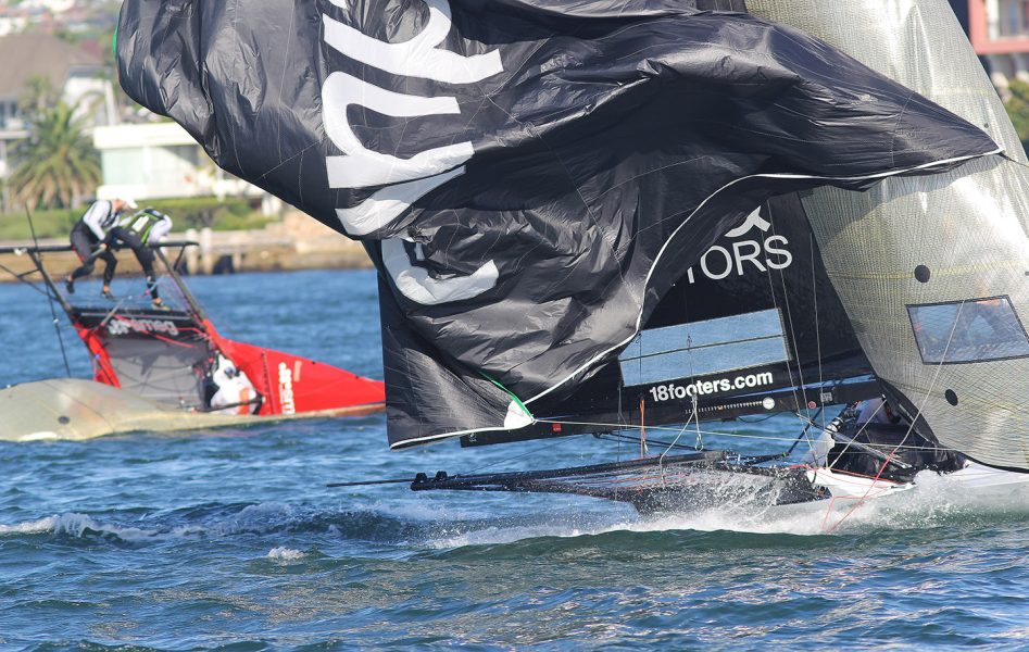 Finport Finance battles with her spinnaker as Smeg capsizes just short of the finish line