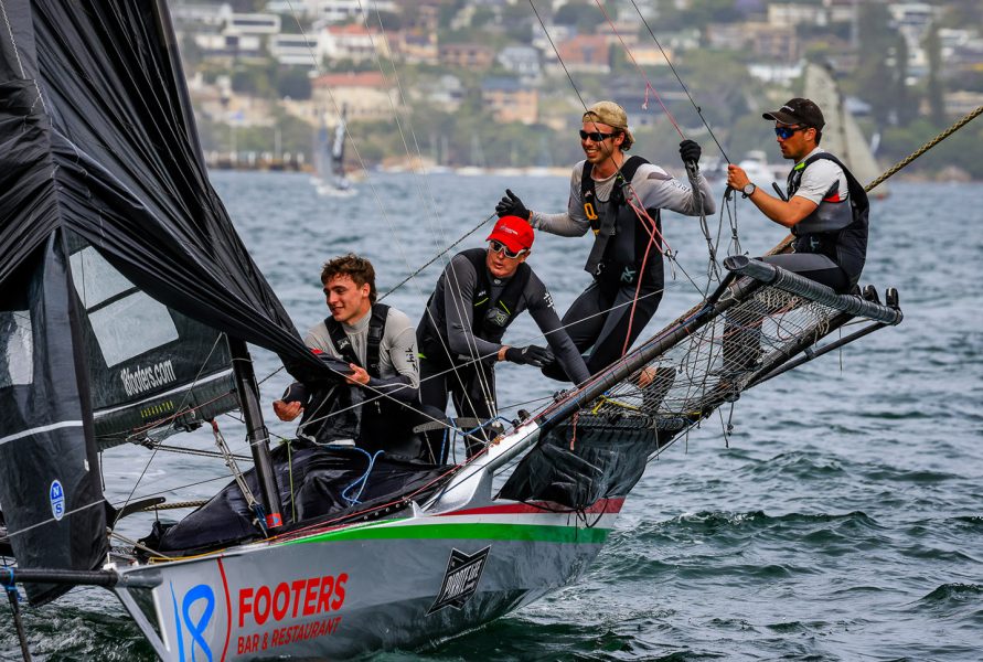 The winning crew as they cross the finish line